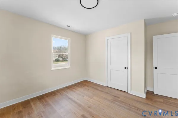 a view of a room with wooden floor and glass door