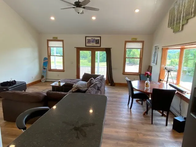 a living room with furniture window and wooden floor