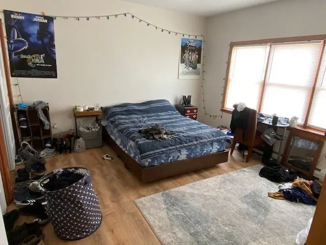 a bedroom with a bed couch and a window