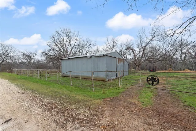 a backyard of a house with lots of green space and fountain