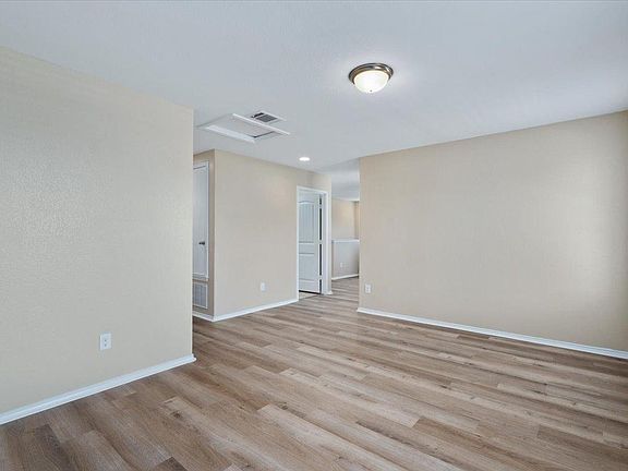 904 Lonesome Lilly Way Pflugerville, TX 78660 - Photo 19 of 34 This interior space features light-colored walls, wood-style flooring, and a ceiling light fixture
