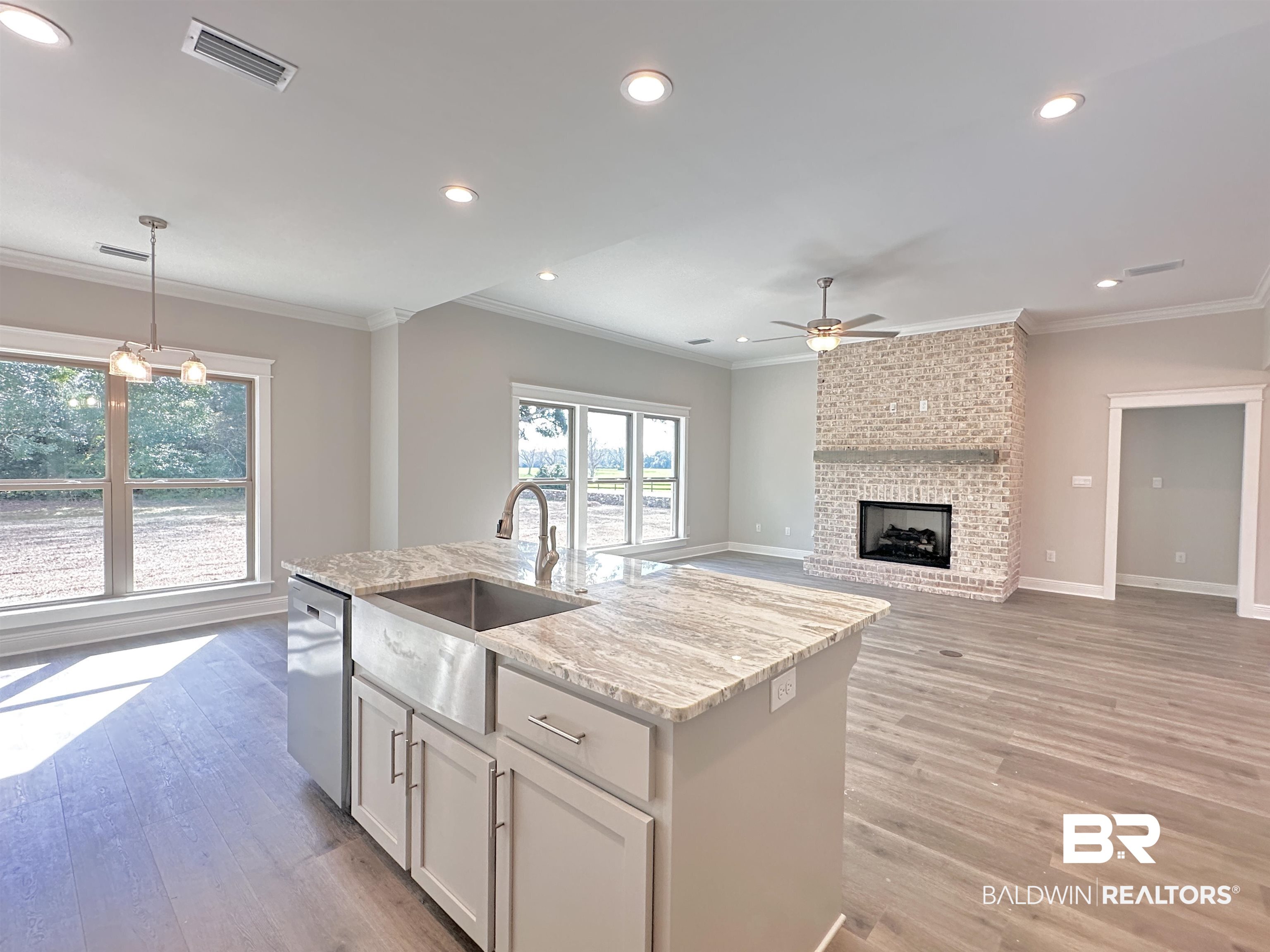630 Kitfox Avenue Fairhope, AL 36532 - Photo 7 of 40 Kitchen featuring dishwasher, sink, white cabinets, hanging light fixtures, and a brick fireplace