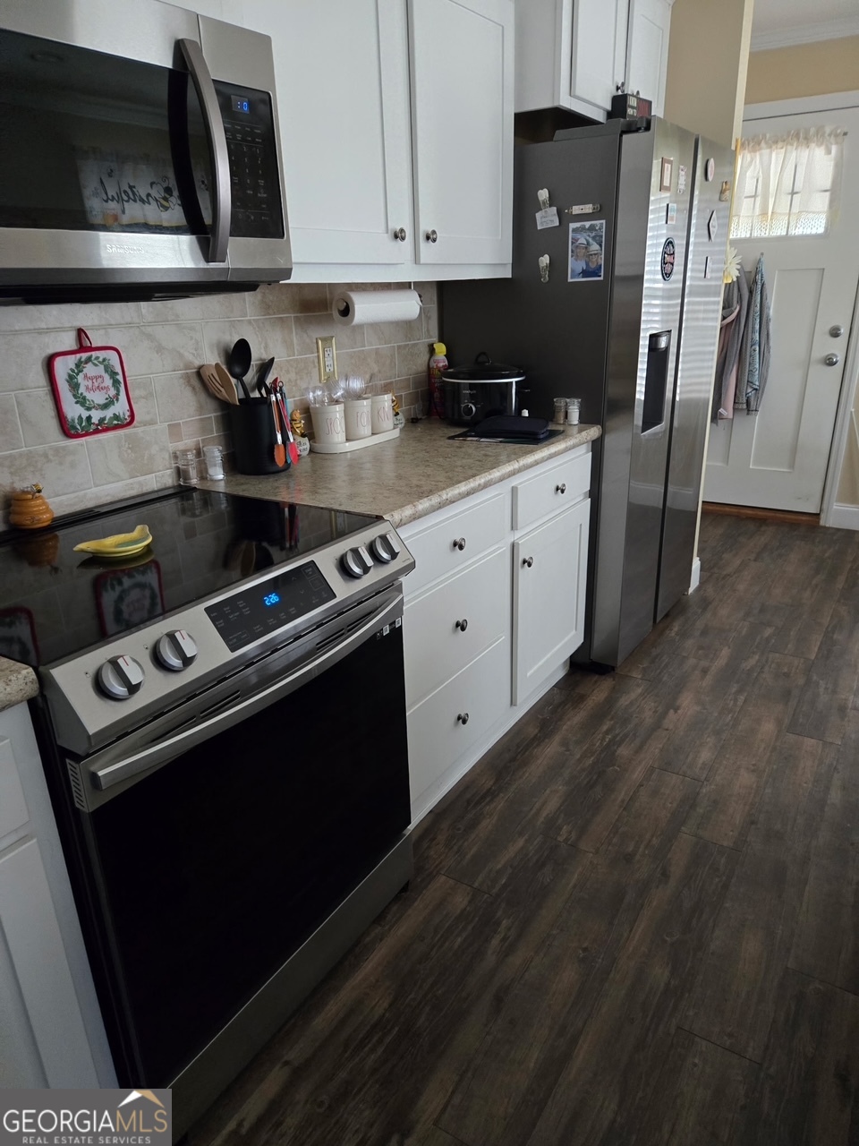 50 Meadowview Street Newnan, GA 30263 - Photo 11 of 26 a kitchen with stainless steel appliances a stove a refrigerator a sink and cabinets