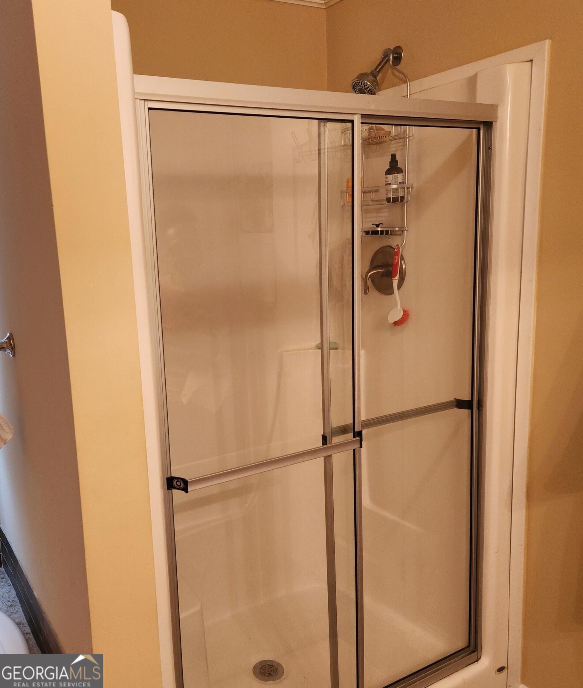50 Meadowview Street Newnan, GA 30263 - Photo 18 of 26 a bathroom with a glass shower door