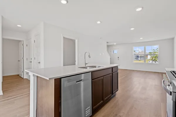 a kitchen with granite countertop a sink and cabinets