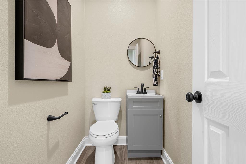 929 Northern Dancer Drive Hewitt, TX 76643 - Photo 29 of 36 a bathroom with a toilet a sink and a mirror