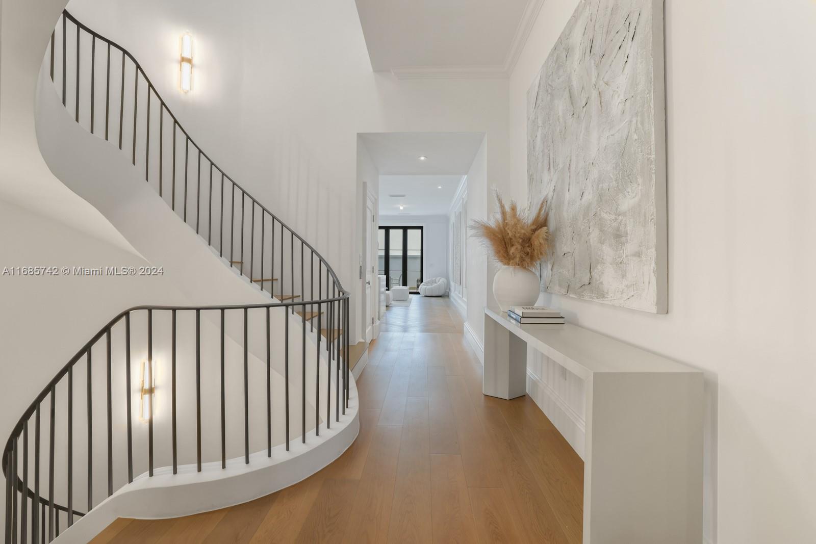 2619 Anderson Road Coral Gables, FL 33134 - Photo 14 of 63 a view of staircase and kitchen with wooden floor