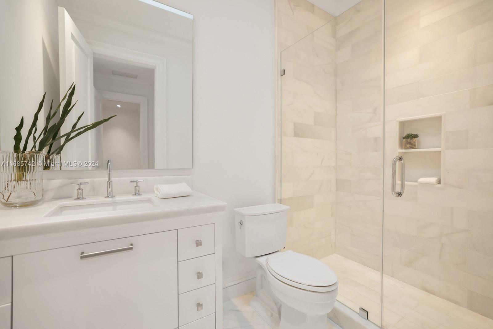 2619 Anderson Road Coral Gables, FL 33134 - Photo 54 of 63 a bathroom with a granite countertop toilet a sink and a mirror