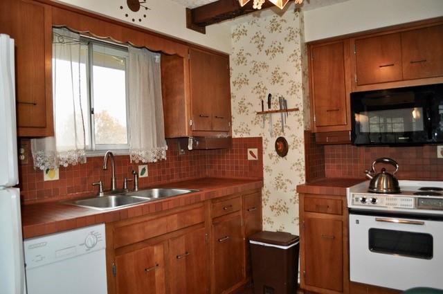305 Parkhill Road Baden, PA 15005 - Photo 8 of 15 a kitchen with stainless steel appliances a sink a stove cabinets and a window