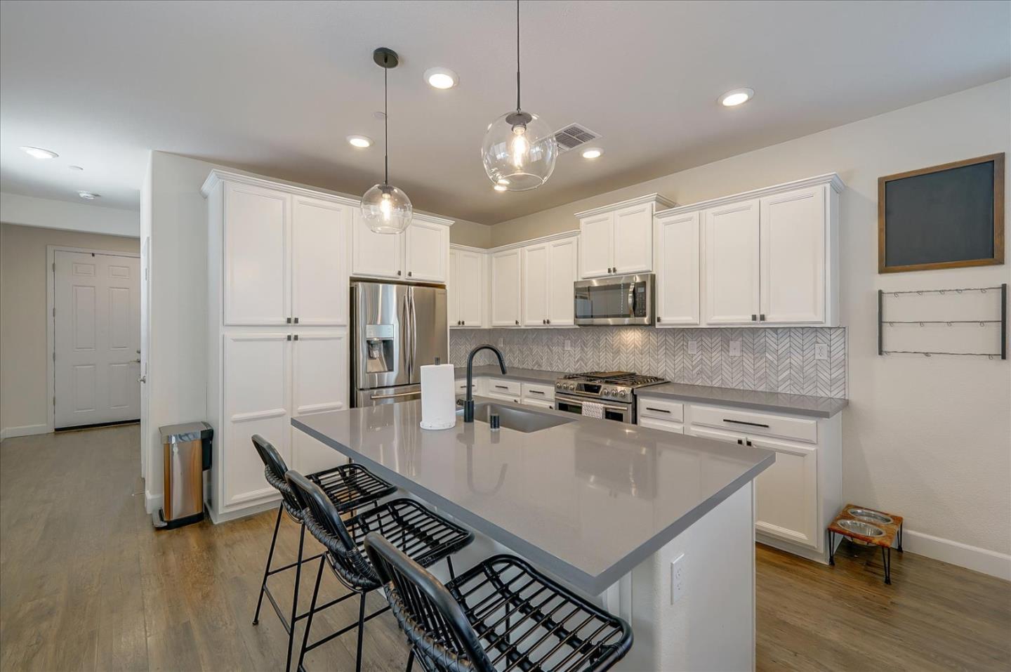 2580 Apple Tree Way Gilroy, CA 95020 - Photo 11 of 45 a kitchen with a dining table chairs sink and microwave