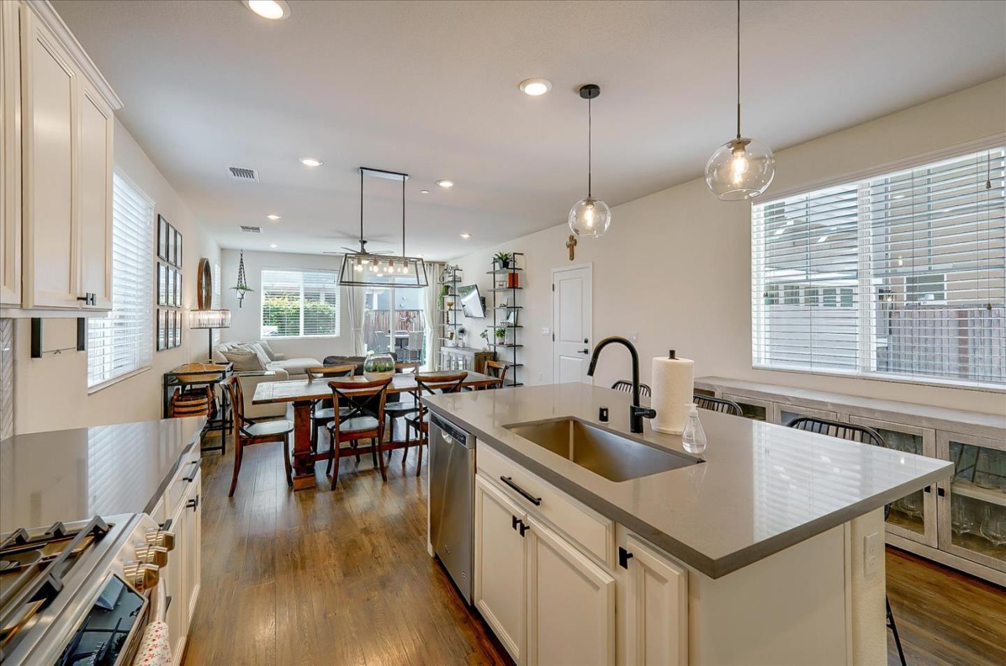 2580 Apple Tree Way Gilroy, CA 95020 - Photo 13 of 45 a kitchen with stainless steel appliances granite countertop a stove a sink a kitchen island with chairs and wooden floor