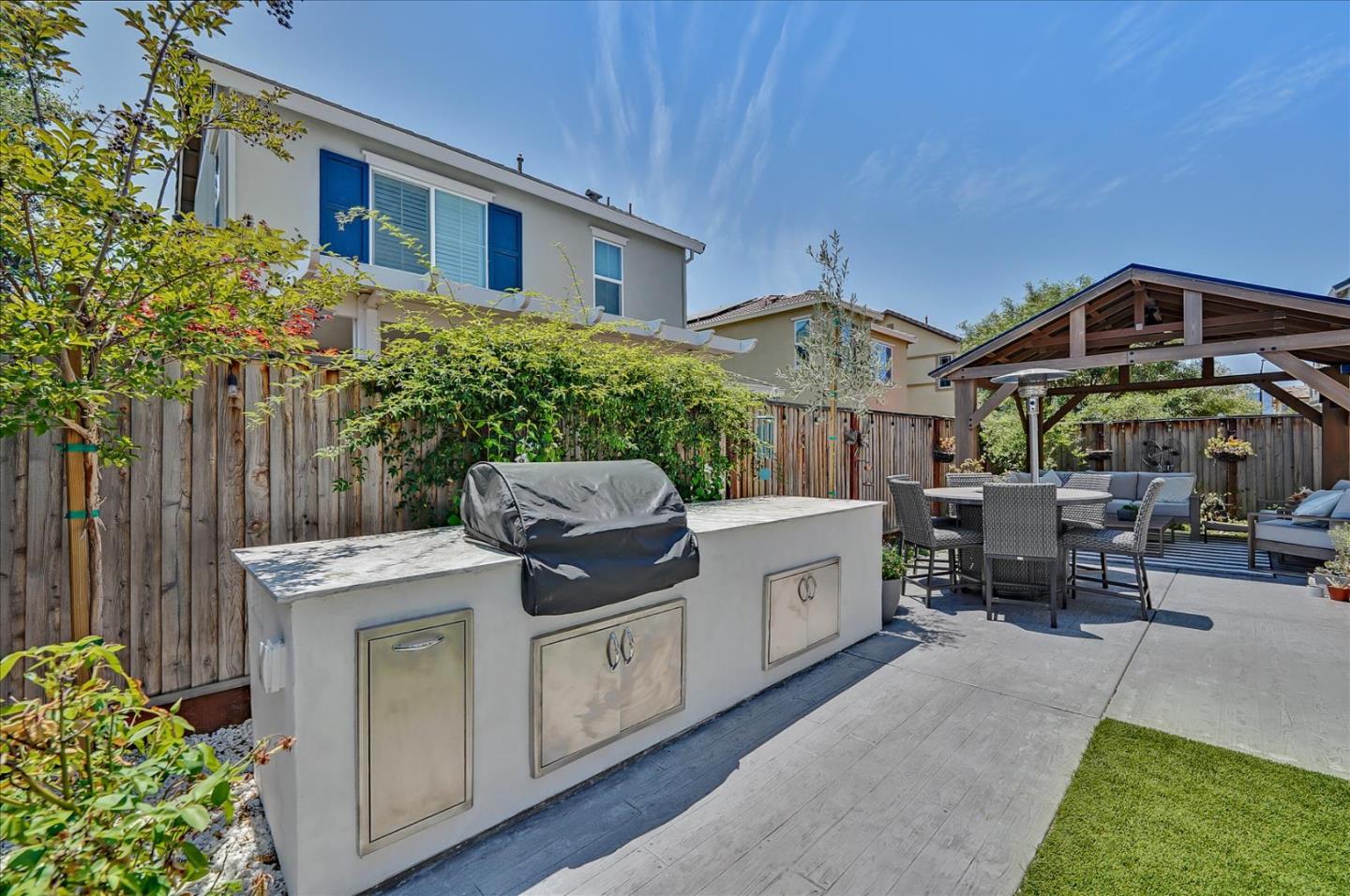 2580 Apple Tree Way Gilroy, CA 95020 - Photo 39 of 45 a view of a patio with table and chairs under an umbrella