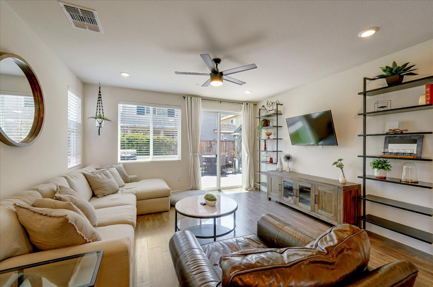 2580 Apple Tree Way Gilroy, CA 95020 - Photo 8 of 45 a living room with furniture a flat screen tv and a large window