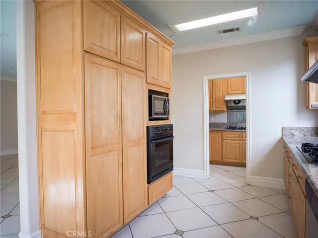 a kitchen with a sink cabinets and window