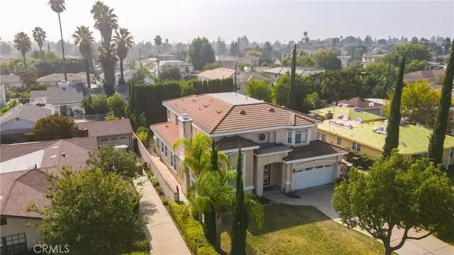an aerial view of a house with a garden and trees