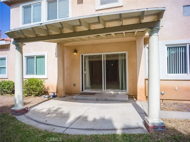 a backyard of a house with plants and large trees
