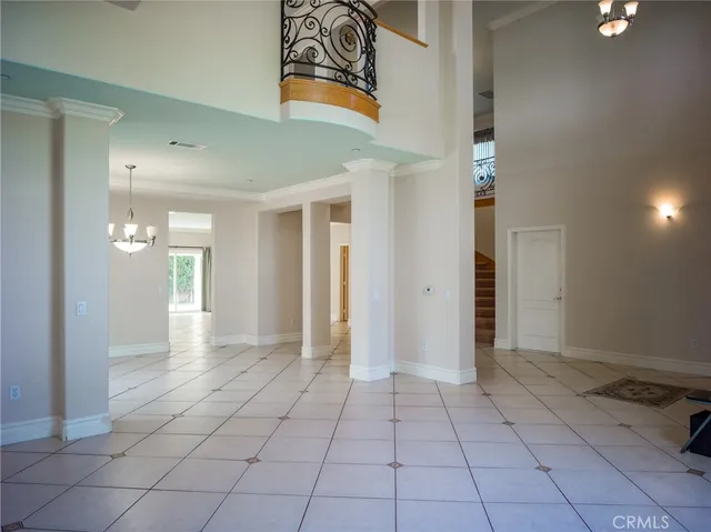 wooden floor with white walls and stairs