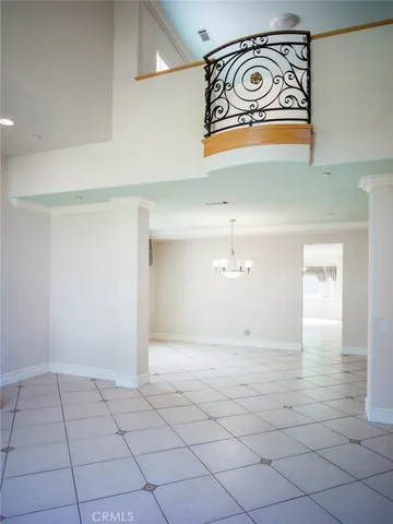 a view of an empty room with window and fire place