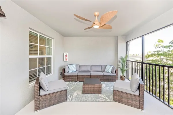 a living room with furniture and a large window