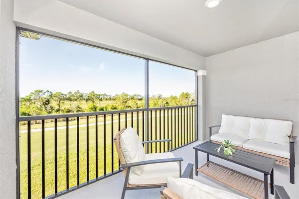 a swimming pool view with a seating space and a garden view