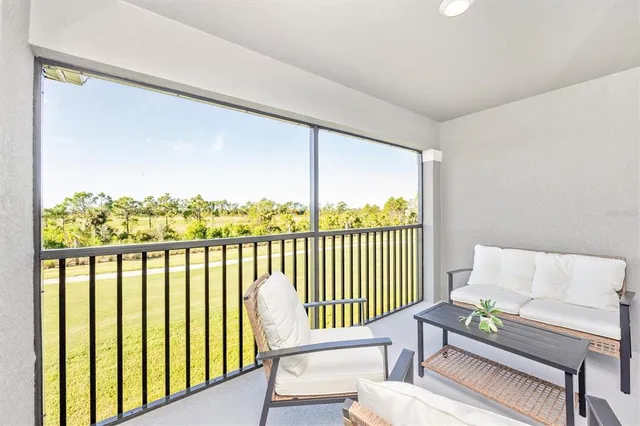a swimming pool view with a seating space and a garden view