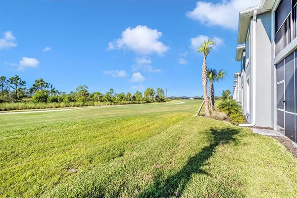 a view of a house with backyard porch and sitting area