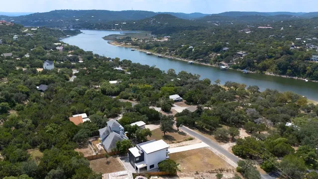 an aerial view of lake residential houses with outdoor space and swimming pool
