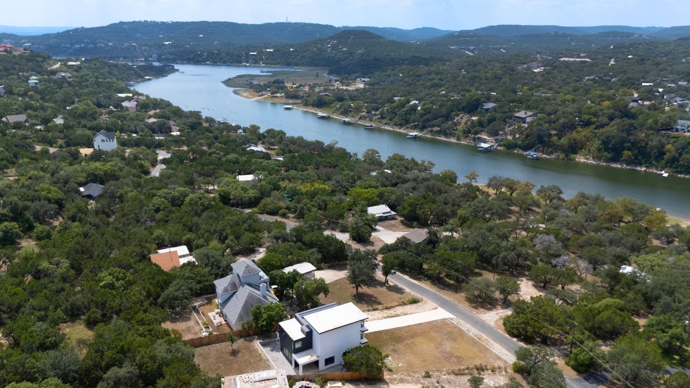 an aerial view of lake residential houses with outdoor space and swimming pool