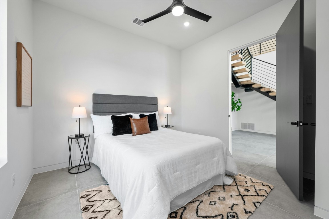 11205 Beach Road Leander, TX 78641 - Photo 17 of 31 a bedroom with a bed and wooden floor