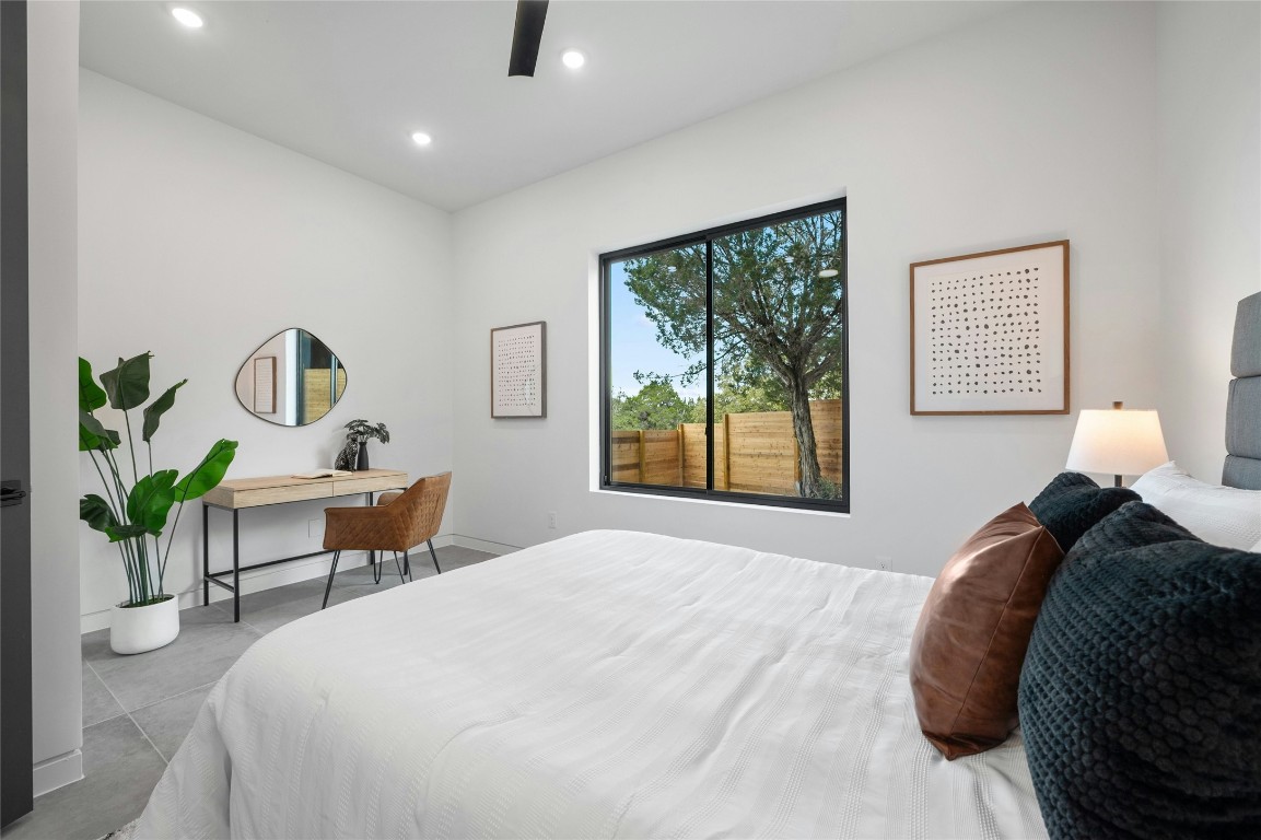 11205 Beach Road Leander, TX 78641 - Photo 18 of 31 a bedroom with a bed lamps and table