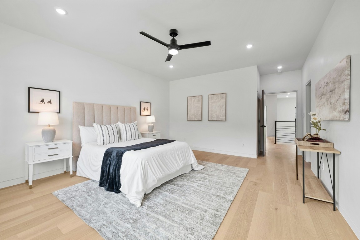 11205 Beach Road Leander, TX 78641 - Photo 21 of 31 a bedroom with a large bed and a chandelier