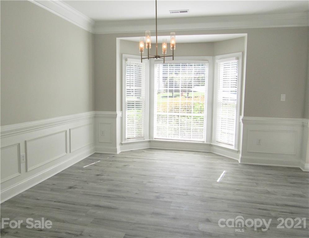 112 Comata Road Mooresville, NC 28117 - Photo 2 of 14 a view of an empty room with wooden floor and a window