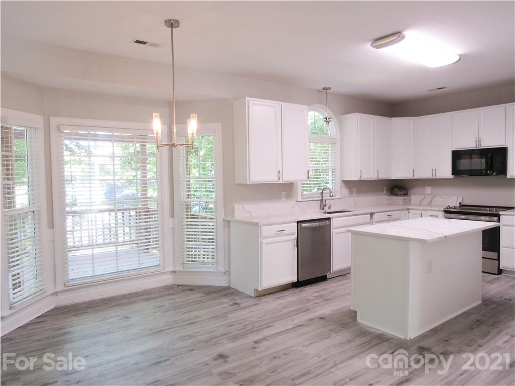 112 Comata Road Mooresville, NC 28117 - Photo 4 of 14 a kitchen with a sink window and white cabinets