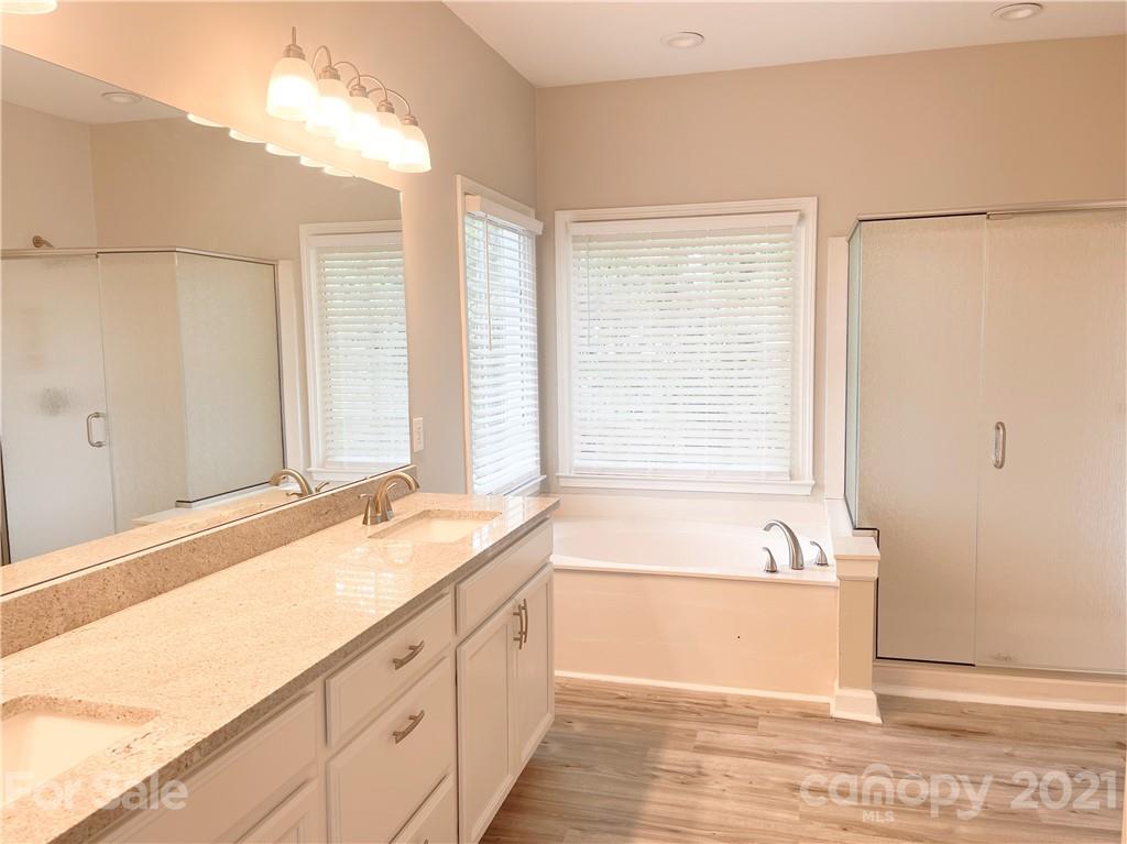 112 Comata Road Mooresville, NC 28117 - Photo 10 of 14 a spacious bathroom with a tub sink and mirror