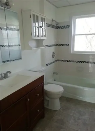 a bathroom with a sink a toilet and bathtub