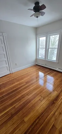wooden floor in an empty room with a window