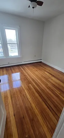 a view of a room with wooden floor