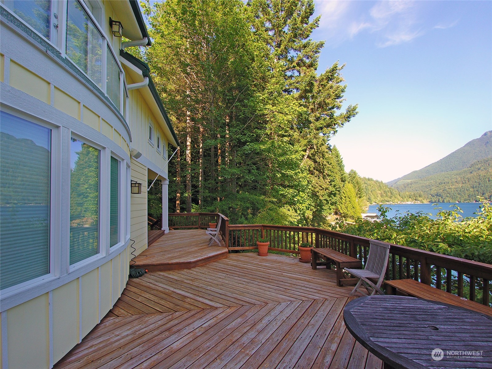 308 Lake Sutherland Road Port Angeles, WA 98363 - Photo 34 of 40 a balcony with wooden floor table and chairs