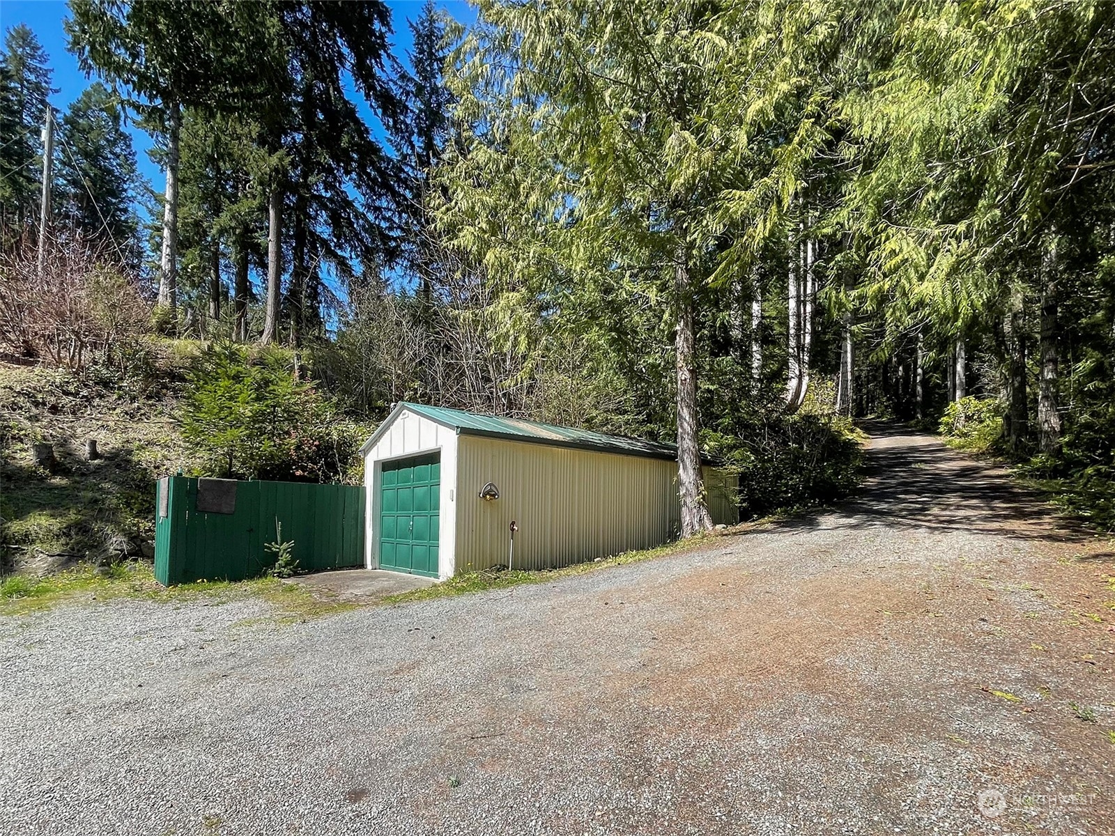 308 Lake Sutherland Road Port Angeles, WA 98363 - Photo 38 of 40 a view of a house with a yard and garage