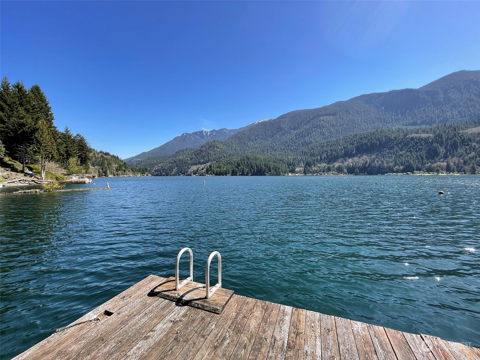 308 Lake Sutherland Road Port Angeles, WA 98363 - Photo 4 of 40 a view of a lake with a mountain in the background
