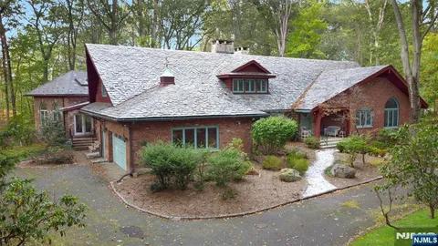 a aerial view of a house with a yard and potted plants