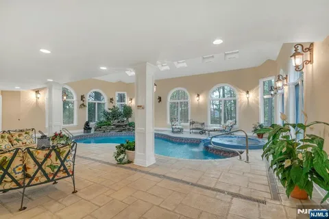 a living room with patio furniture and a fireplace