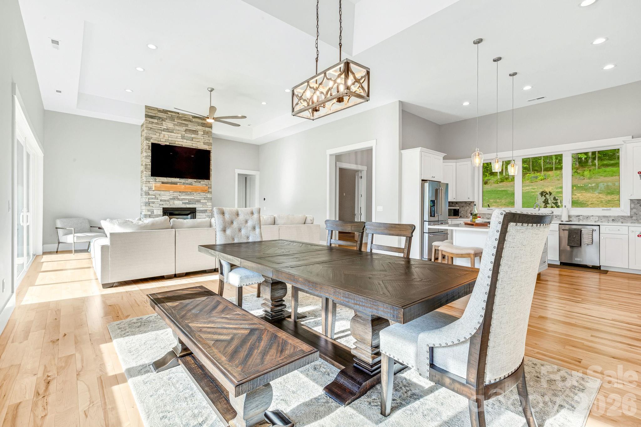 128 Saddle Ridge Drive Alexander, NC 28701 - Photo 11 of 33 a view of a dining room with furniture a chandelier and wooden floor