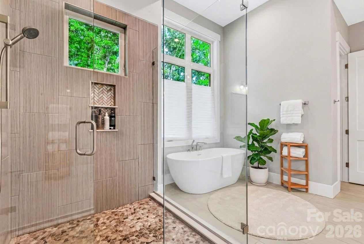 128 Saddle Ridge Drive Alexander, NC 28701 - Photo 18 of 33 a spacious bathroom with a granite countertop tub shower and window