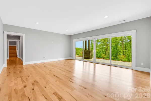 a bedroom with a large bed and a large window