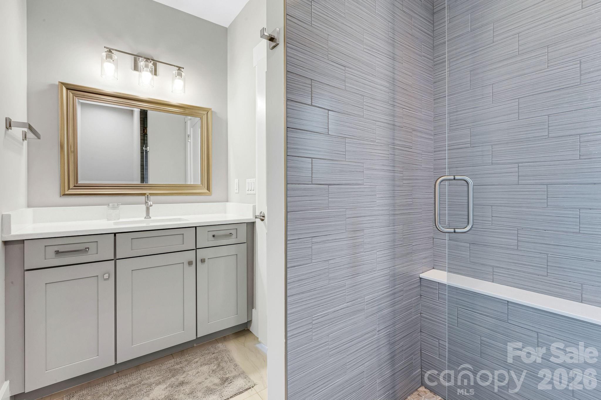 128 Saddle Ridge Drive Alexander, NC 28701 - Photo 33 of 33 a bathroom with a sink vanity and mirror