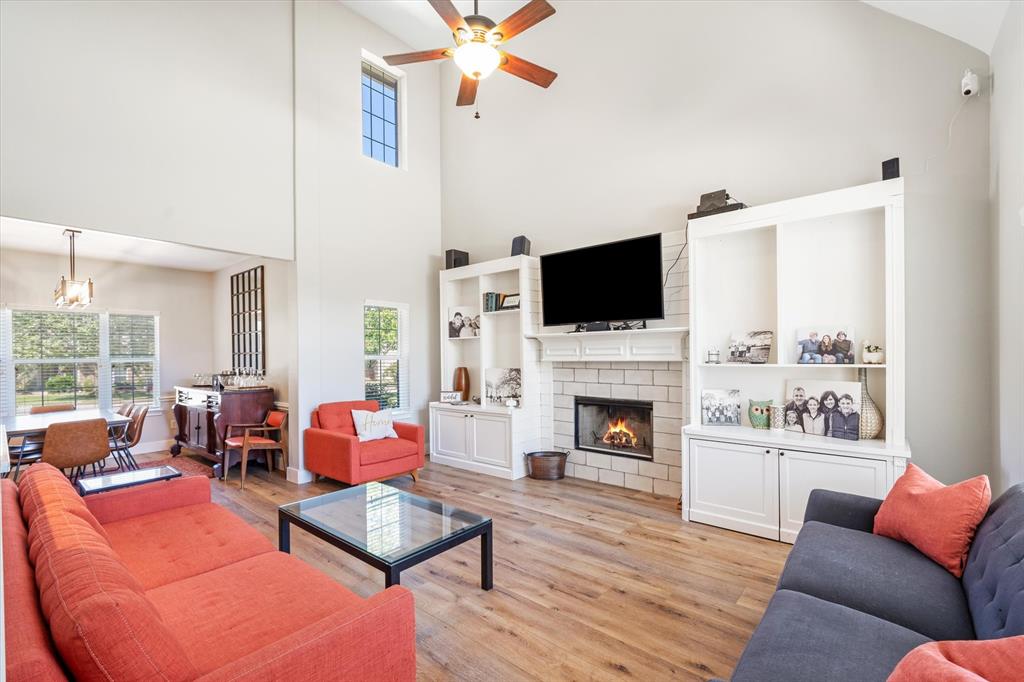 a living room with furniture a fireplace and a flat screen tv