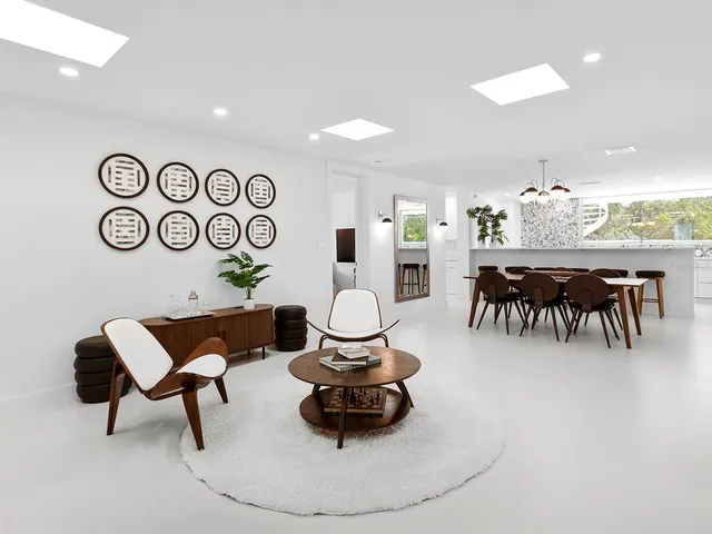 a dining room with furniture and a floor to ceiling window