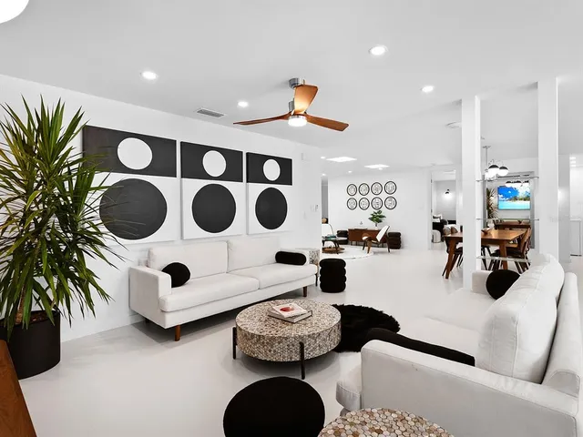 a bedroom with a bed and a large mirror