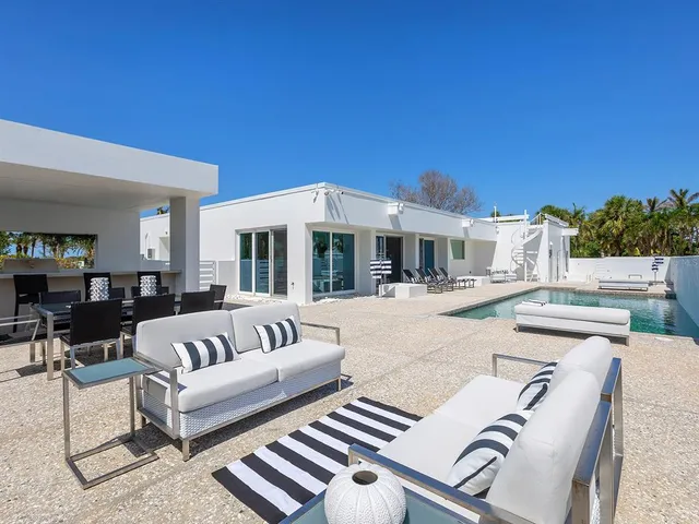 a view of a patio with swimming pool and sitting area
